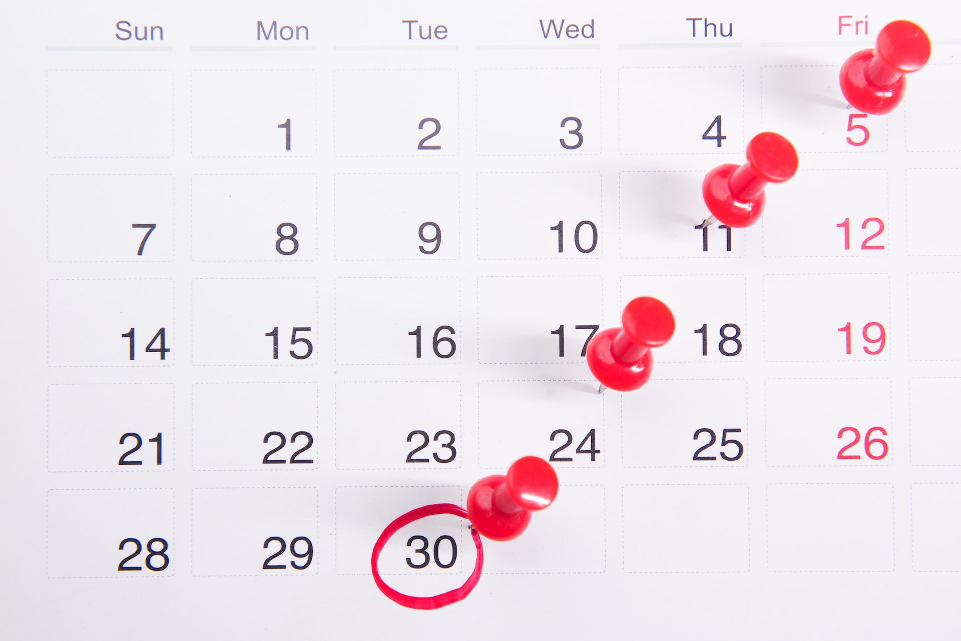 White calendar with red pins